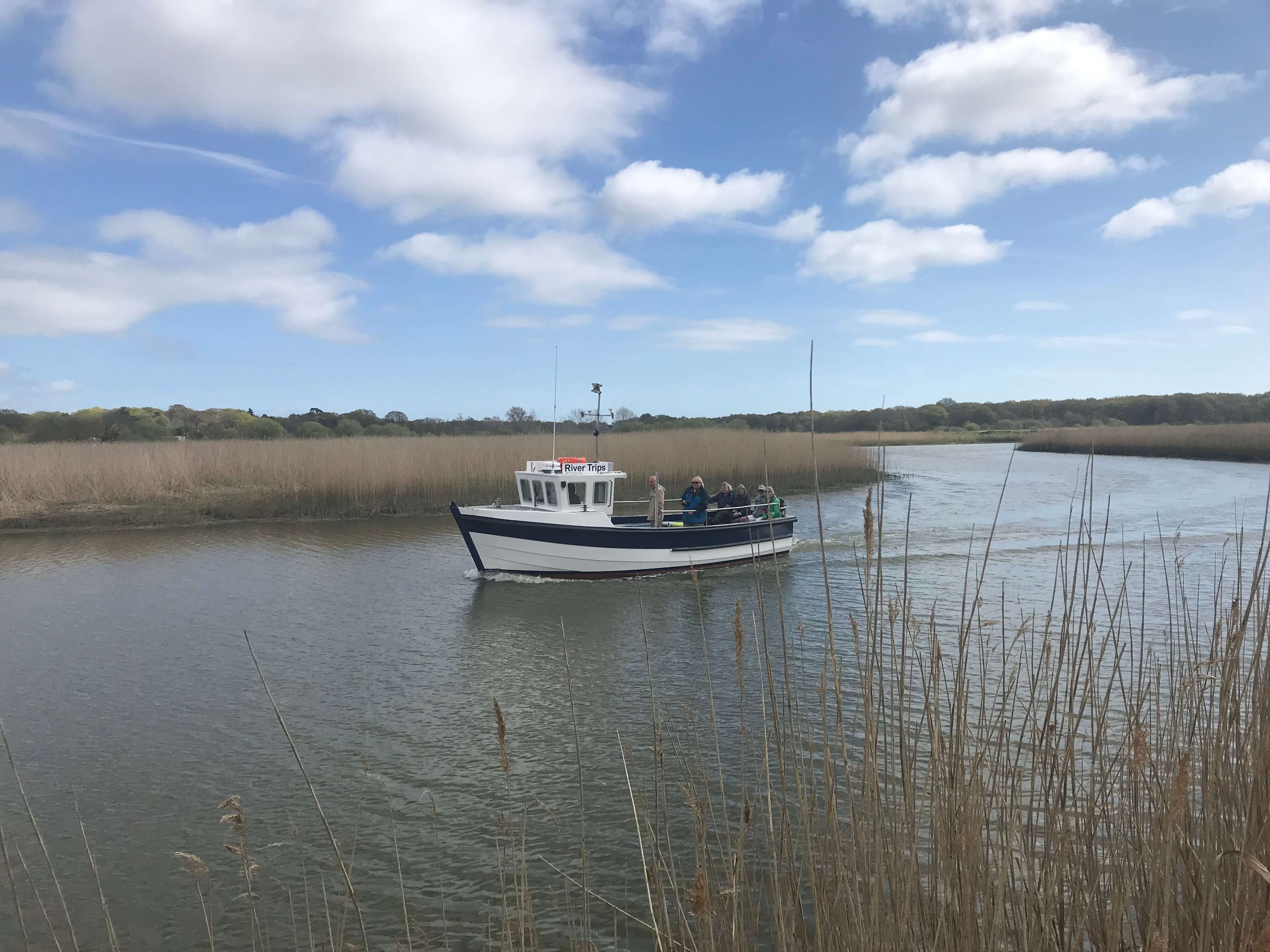 The Tilly Too on the water between reed banks on the river Alde