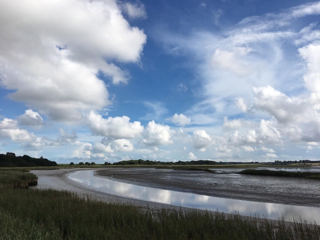 A view of the river Alde bending with muddy banks
