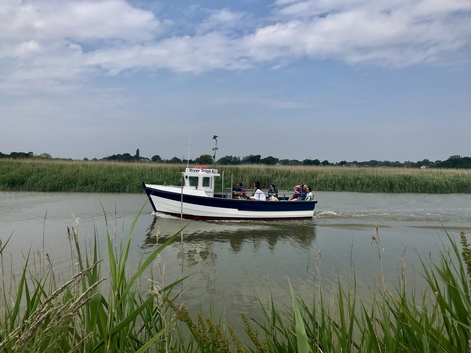 The Tilly Too on the water between reed banks on the river Alde